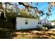 A charming white home surrounded by lush greenery and a stone path at 9161 Codel Loop, New Port Richey, FL 34654