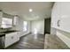 Bright kitchen features stainless steel appliances, granite countertops, and grey wood-look floors at 9161 Codel Loop, New Port Richey, FL 34654