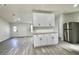 Bright kitchen with granite countertops, stainless steel refrigerator, and plenty of storage space at 9161 Codel Loop, New Port Richey, FL 34654