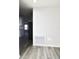 This living room has wood-look floors and is painted white at 9161 Codel Loop, New Port Richey, FL 34654