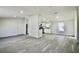Spacious living room with updated flooring and ample natural light, flowing into the kitchen area at 9161 Codel Loop, New Port Richey, FL 34654