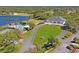 Aerial of clubhouse, pool and tennis courts with beautiful landscaping and lake views at 9398 N Burnam Dr, Weeki Wachee, FL 34613