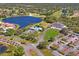 Extensive aerial view showcasing community amenities, including a pool, tennis courts, golf course, and lake at 9398 N Burnam Dr, Weeki Wachee, FL 34613