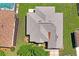 Bird's-eye view of a house featuring a durable roof, an adjacent screened-in pool, and a private backyard at 9398 N Burnam Dr, Weeki Wachee, FL 34613
