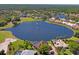 Scenic aerial view of a community featuring a lake, pool, golf course and luxury homes at 9398 N Burnam Dr, Weeki Wachee, FL 34613