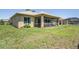 Spacious backyard showcasing a covered patio and well-maintained lawn at 9398 N Burnam Dr, Weeki Wachee, FL 34613