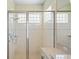 Glass enclosed shower with tile and a built in showerhead nozzle provides a spa-like experience at 9398 N Burnam Dr, Weeki Wachee, FL 34613