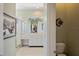Bright bathroom featuring a spacious vanity, framed art, and a glass-enclosed shower at 9398 N Burnam Dr, Weeki Wachee, FL 34613