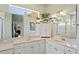 Light and bright bathroom with double sinks, a vanity, and a large mirror at 9398 N Burnam Dr, Weeki Wachee, FL 34613