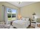 Cozy bedroom with a large window, a plush bed with decorative pillows, and natural light at 9398 N Burnam Dr, Weeki Wachee, FL 34613