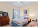 Comfortable bedroom with a window letting in plenty of natural light, complemented by calming blue accents at 9398 N Burnam Dr, Weeki Wachee, FL 34613