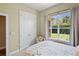 Bedroom featuring a view of tropical plants, closet, neutral decor, and carpet at 9398 N Burnam Dr, Weeki Wachee, FL 34613