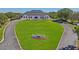 View of the clubhouse from a drone, showcasing lush green lawn and beautiful landscaping at 9398 N Burnam Dr, Weeki Wachee, FL 34613