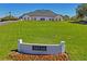 Clubhouse featuring manicured grounds, complemented by lush greenery and a clear blue sky at 9398 N Burnam Dr, Weeki Wachee, FL 34613