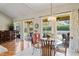 Dining room area with access to the lanai and modern lighting at 9398 N Burnam Dr, Weeki Wachee, FL 34613