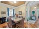 Formal dining room features wood floors, a marble table, and natural light from the window at 9398 N Burnam Dr, Weeki Wachee, FL 34613