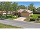 Well-maintained home featuring a two-car garage and inviting landscaping at 9398 N Burnam Dr, Weeki Wachee, FL 34613