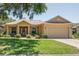 Charming single Gathering home with a lush green lawn, two-car garage, and a welcoming front porch at 9398 N Burnam Dr, Weeki Wachee, FL 34613