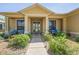Inviting front porch with comfortable seating, lush landscaping, and a charming walkway at 9398 N Burnam Dr, Weeki Wachee, FL 34613