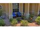 A welcoming front porch adorned with blue cushioned chairs and lush landscaping at 9398 N Burnam Dr, Weeki Wachee, FL 34613