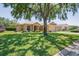 Inviting home with a well-manicured lawn and mature landscaping, shaded by a large tree at 9398 N Burnam Dr, Weeki Wachee, FL 34613