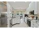 Bright kitchen with stainless appliances, granite counters, and ample cabinet space at 9398 N Burnam Dr, Weeki Wachee, FL 34613