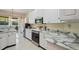 Well-lit kitchen featuring stainless appliances, granite counters, and ample storage at 9398 N Burnam Dr, Weeki Wachee, FL 34613