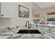 Kitchen with stainless steel sink, granite countertops, and lots of natural light at 9398 N Burnam Dr, Weeki Wachee, FL 34613