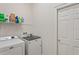 Functional laundry room featuring a washer, dryer, and shelving for supplies at 9398 N Burnam Dr, Weeki Wachee, FL 34613