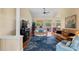 Cozy living room with hardwood floors, large windows, and comfortable seating area at 9398 N Burnam Dr, Weeki Wachee, FL 34613