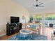 Bright living room with modern ceiling fan and sliding doors to the lanai at 9398 N Burnam Dr, Weeki Wachee, FL 34613