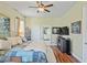 A spacious main bedroom features wood floors, a ceiling fan, and neutral paint colors at 9398 N Burnam Dr, Weeki Wachee, FL 34613