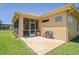 Rear patio with tile flooring, a screened in area, and a grill, ideal for outdoor entertainment at 9398 N Burnam Dr, Weeki Wachee, FL 34613