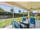 Screened patio with comfortable seating and a view of the manicured lawn at 9398 N Burnam Dr, Weeki Wachee, FL 34613