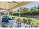 Cozy screened patio with ceiling fans and comfortable blue furniture, perfect for outdoor relaxation at 9398 N Burnam Dr, Weeki Wachee, FL 34613