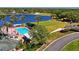 Aerial showing large swimming pool, tennis courts, and surrounding greenery near the lake at 9398 N Burnam Dr, Weeki Wachee, FL 34613