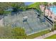 Overhead view of well-maintained tennis courts, shaded benches, and mature trees in a quiet, green setting at 9398 N Burnam Dr, Weeki Wachee, FL 34613