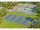 Overhead view of multiple tennis and pickleball courts in a well-maintained community sports complex at 9398 N Burnam Dr, Weeki Wachee, FL 34613