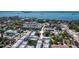 Aerial view of a townhome community with a glimpse of the waterfront in the distance at 946 Highland Ave # 47, Dunedin, FL 34698