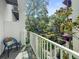 Balcony with white railings overlooking manicured green space and beautiful trees at 946 Highland Ave # 47, Dunedin, FL 34698