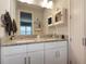 Bathroom with double vanity, granite countertops and white cabinets at 946 Highland Ave # 47, Dunedin, FL 34698