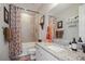 Clean bathroom with vanity, framed mirror, granite countertop, and shower with curtain at 946 Highland Ave # 47, Dunedin, FL 34698