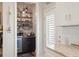 Charming coffee bar area featuring open shelving, a beverage fridge, and a coffee maker at 946 Highland Ave # 47, Dunedin, FL 34698