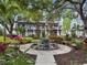 Beautiful landscaped courtyard featuring a decorative water feature and lush plants at 946 Highland Ave # 47, Dunedin, FL 34698