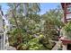 Beautifully landscaped courtyard with mature trees, vibrant flowers, and walkways at 946 Highland Ave # 47, Dunedin, FL 34698