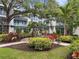 Beautiful courtyard view with lush tropical greenery and shade canopy seating area at 946 Highland Ave # 47, Dunedin, FL 34698