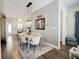 Open dining space with modern lighting fixture and access to the living room and kitchen at 946 Highland Ave # 47, Dunedin, FL 34698