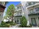 Charming multi-story condo with white exterior, green trim, and balconies overlooking landscaped grounds at 946 Highland Ave # 47, Dunedin, FL 34698