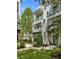 Charming multi-story exterior featuring white facades, balconies and lush garden views at 946 Highland Ave # 47, Dunedin, FL 34698