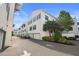 Exterior view of multi-story townhomes featuring garages and manicured landscaping at 946 Highland Ave # 47, Dunedin, FL 34698